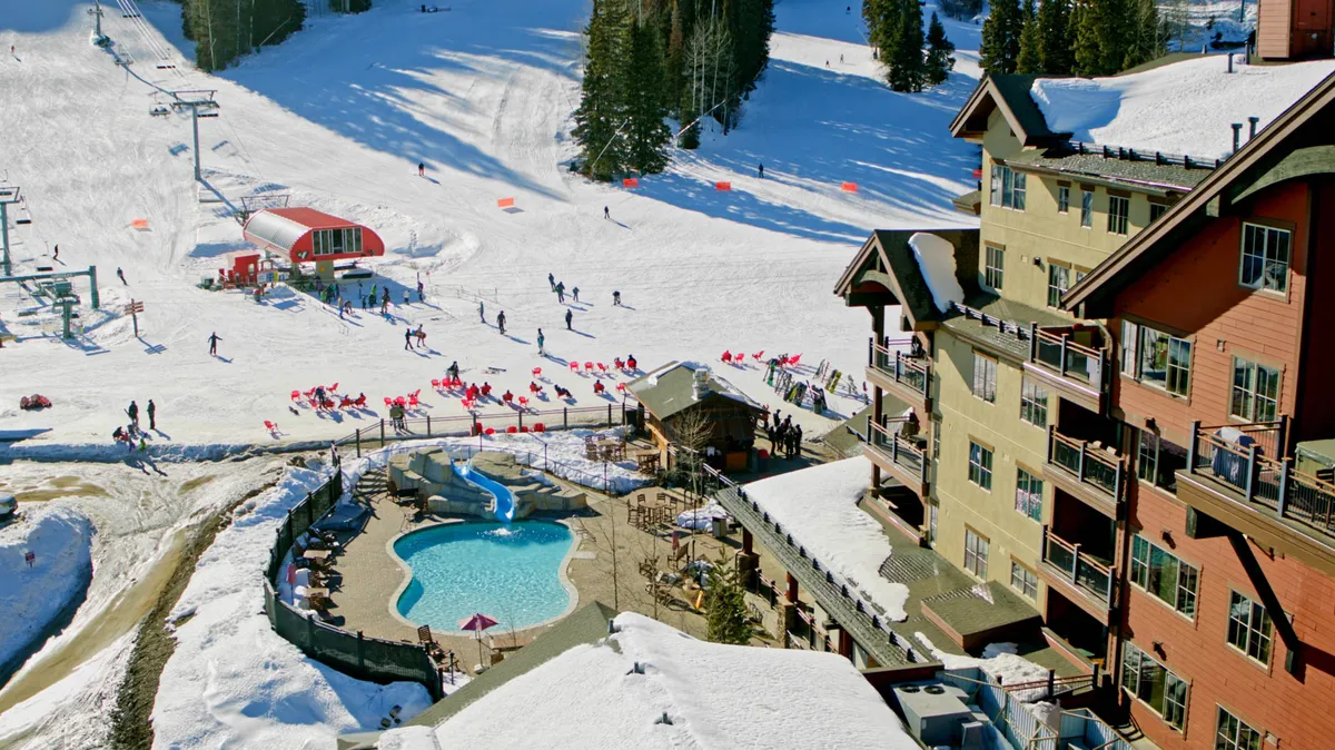This image captures the vibrant outdoor experience at Purgatory Resort, featuring skiers enjoying the slopes, a heated outdoor pool, and the resort buildings nestled in the snowy landscape. The presence of active guests and amenities ties directly to the section's emphasis on both adventure and relaxation.